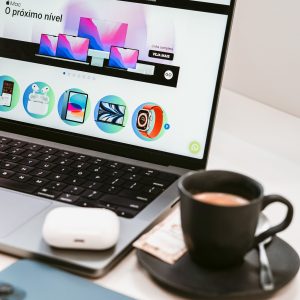 A stylish workspace featuring a laptop, smartphone, and coffee cup, embodying a modern tech lifestyle.